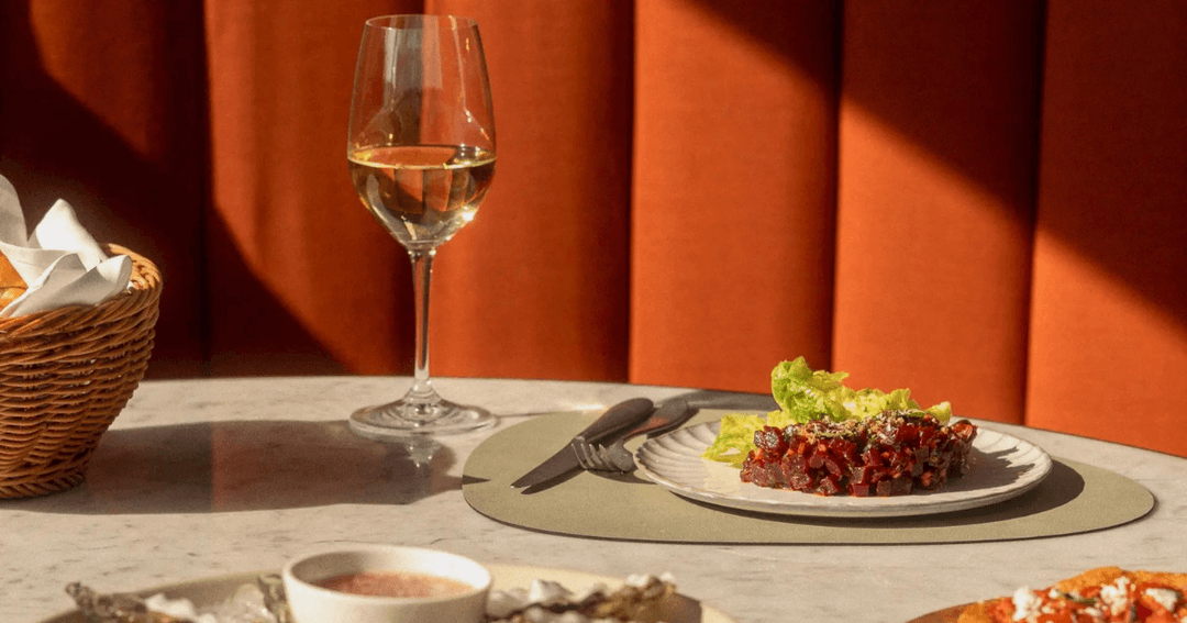 A plate of beet tartare with a glass of white wine at Alizée, Banyan Tree, Bluewaters Dubai