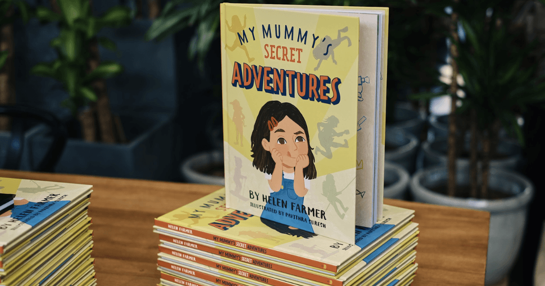 A stack of "My Mummy's Secret Adventures" children's books by Helen Farmer on display at Mina's Kitchen.