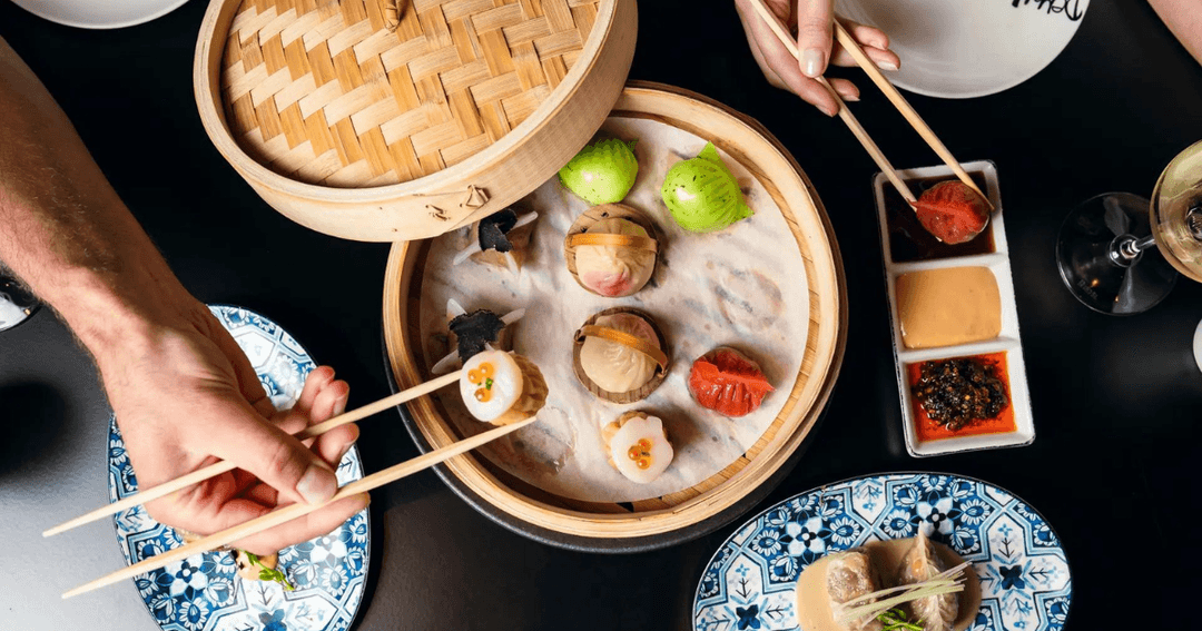 Colorful assortment of dim sum served in a bamboo steamer at Demon Duck, Banyan Tree, Bluewaters Dubai