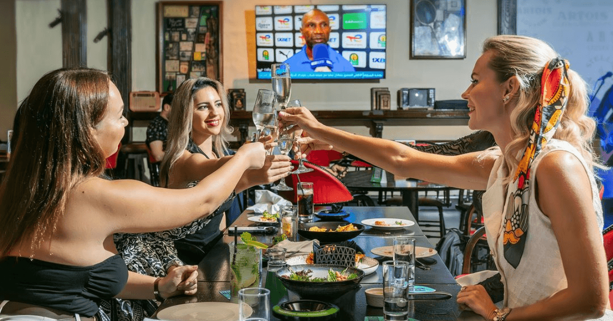 guests cheering their drinks at harvesters