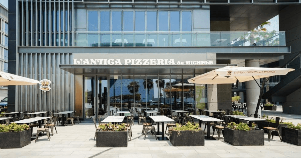 Exterior view of L'Antica Pizzeria da Michele in City Walk, Dubai, featuring outdoor seating and signage.